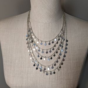Multi strand tiered metallic silver necklace